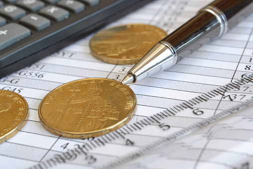 Financial background with money, calculator, table and pen.